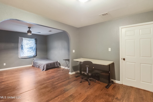 bedroom with dark hardwood / wood-style floors