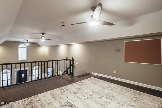 bonus room featuring dark wood-type flooring and vaulted ceiling