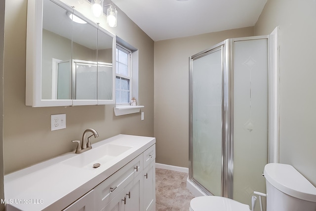 bathroom with a shower with door, vanity, and toilet