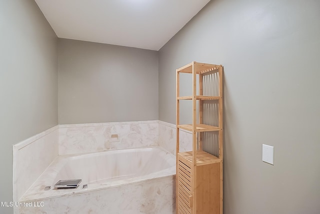 bathroom featuring a relaxing tiled tub