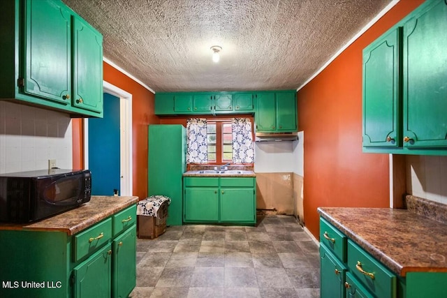 kitchen featuring sink and a textured ceiling