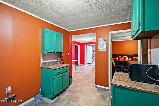 kitchen featuring ornamental molding and a textured ceiling