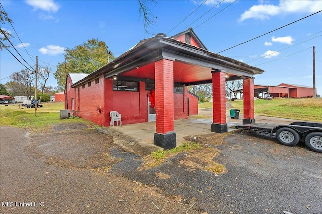 view of side of property featuring a carport and central air condition unit