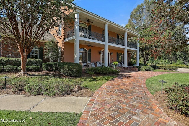 607 Tiffintown Rd, Vicksburg, MS 39183 - greek revival inspired property with stucco siding, a porch, a ceiling fan, and a balcony