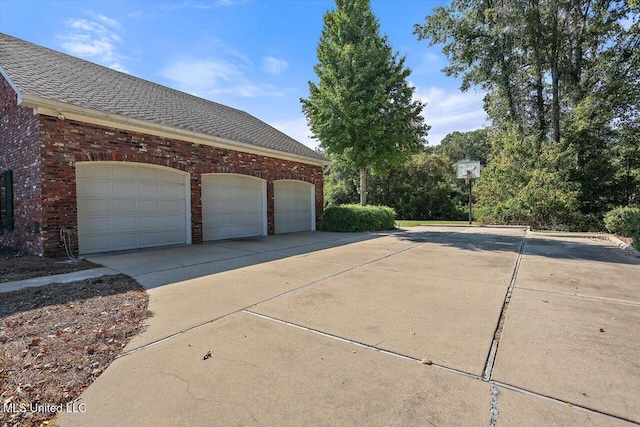 607 Tiffintown Rd, Vicksburg, MS 39183 - view of home's exterior featuring concrete driveway, brick siding, and a shingled roof