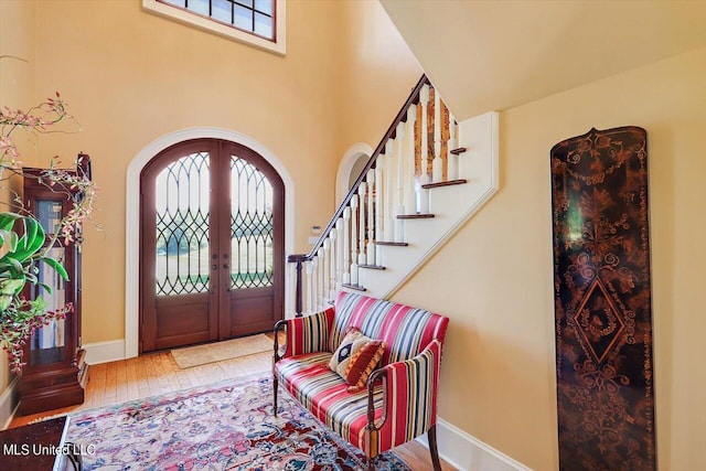 607 Tiffintown Rd, Vicksburg, MS 39183 - foyer entrance with french doors, arched walkways, baseboards, stairs, and wood-type flooring