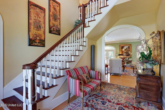 607 Tiffintown Rd, Vicksburg, MS 39183 - stairway with arched walkways, wood finished floors, and ornamental molding