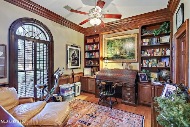 607 Tiffintown Rd, Vicksburg, MS 39183 - home office featuring light wood-style flooring, wainscoting, built in shelves, a ceiling fan, and crown molding