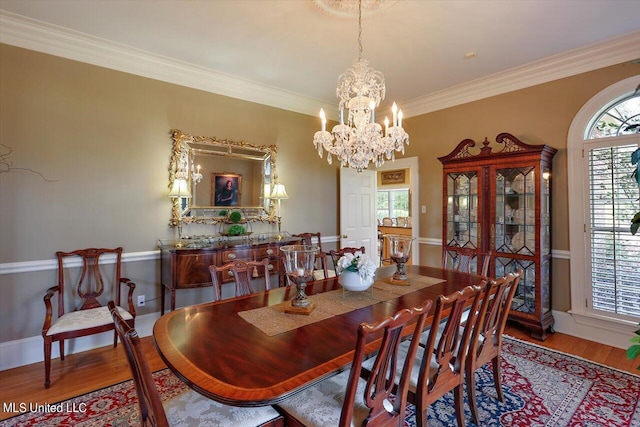 607 Tiffintown Rd, Vicksburg, MS 39183 - dining space featuring wood finished floors, crown molding, and an inviting chandelier