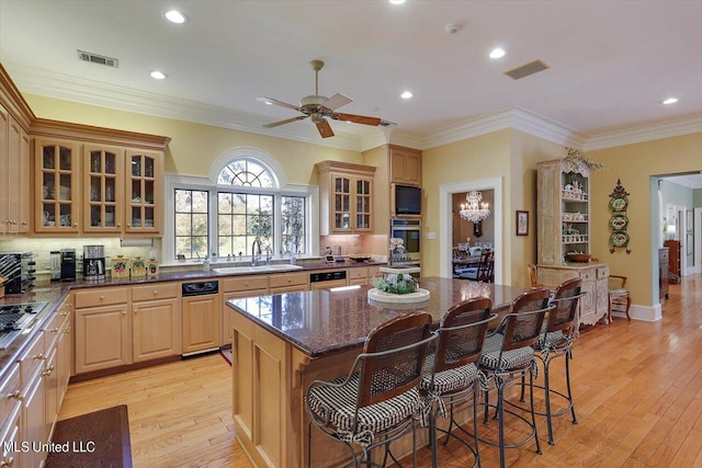607 Tiffintown Rd, Vicksburg, MS 39183 - kitchen with stainless steel oven, visible vents, a breakfast bar area, and a sink