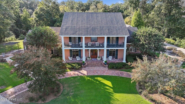 607 Tiffintown Rd, Vicksburg, MS 39183 - view of front of property with a porch, a balcony, a front yard, and stucco siding