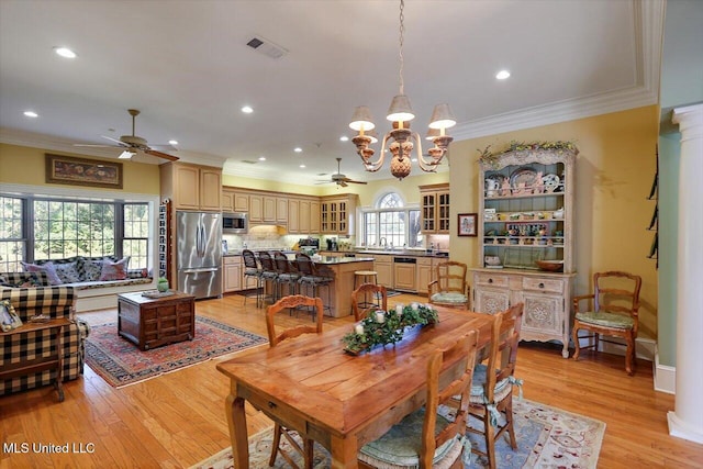 607 Tiffintown Rd, Vicksburg, MS 39183 - dining room with ceiling fan with notable chandelier, visible vents, light wood finished floors, and ornamental molding
