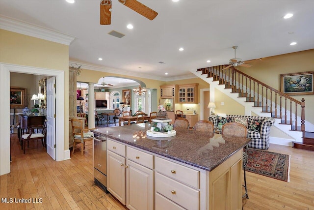 607 Tiffintown Rd, Vicksburg, MS 39183 - kitchen with ceiling fan with notable chandelier, a breakfast bar, decorative columns, ornamental molding, and a kitchen island