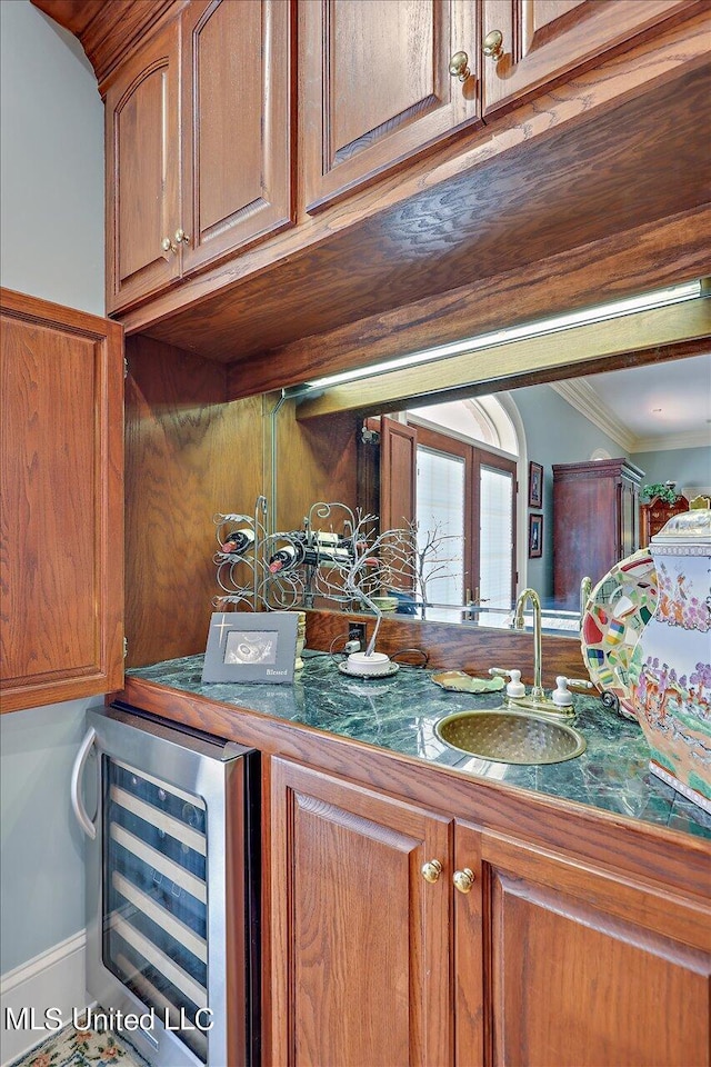 607 Tiffintown Rd, Vicksburg, MS 39183 - interior space featuring wine cooler, a sink, brown cabinets, crown molding, and tile countertops