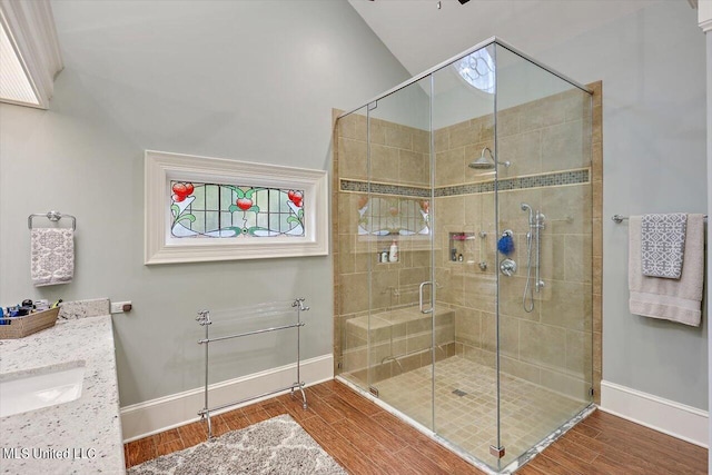 607 Tiffintown Rd, Vicksburg, MS 39183 - bathroom featuring wood finished floors, baseboards, a stall shower, and a sink