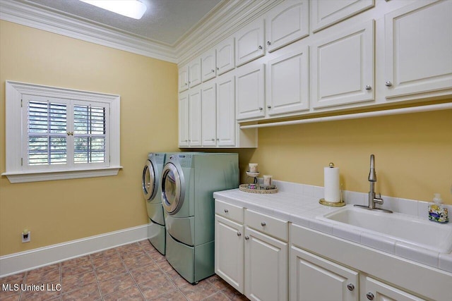 607 Tiffintown Rd, Vicksburg, MS 39183 - laundry area featuring crown molding, a sink, washer and dryer, cabinet space, and baseboards