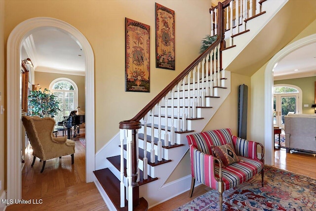 607 Tiffintown Rd, Vicksburg, MS 39183 - stairway with arched walkways, wood finished floors, and ornamental molding