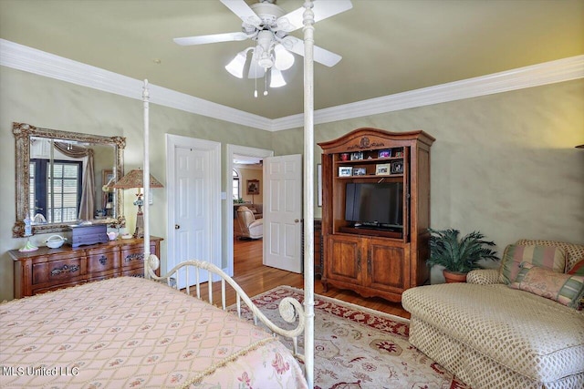 607 Tiffintown Rd, Vicksburg, MS 39183 - bedroom with wood finished floors, crown molding, and a ceiling fan