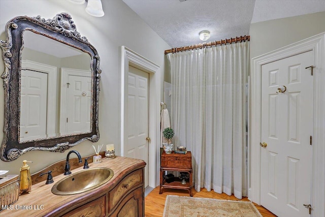 607 Tiffintown Rd, Vicksburg, MS 39183 - full bath with vanity, wood finished floors, and a textured ceiling