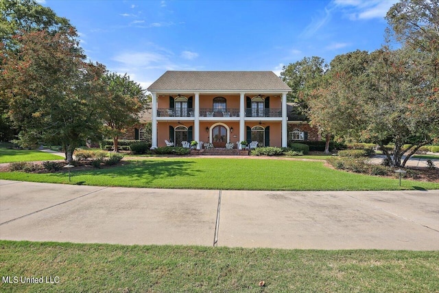 607 Tiffintown Rd, Vicksburg, MS 39183 - greek revival house with stucco siding, a front lawn, a porch, and a balcony