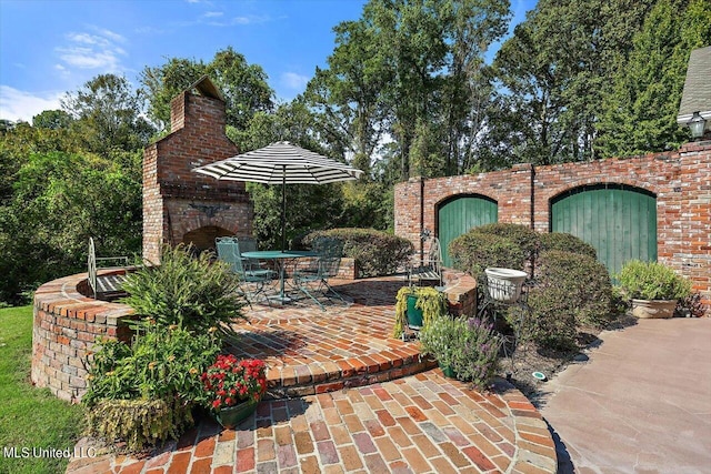 607 Tiffintown Rd, Vicksburg, MS 39183 - view of patio featuring outdoor dining space and an outdoor brick fireplace