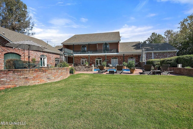 607 Tiffintown Rd, Vicksburg, MS 39183 - back of house featuring brick siding, a patio area, a balcony, a yard, and an outdoor pool