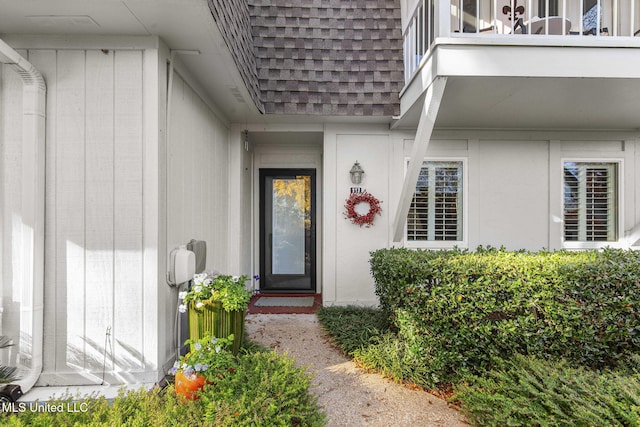 view of exterior entry featuring a balcony