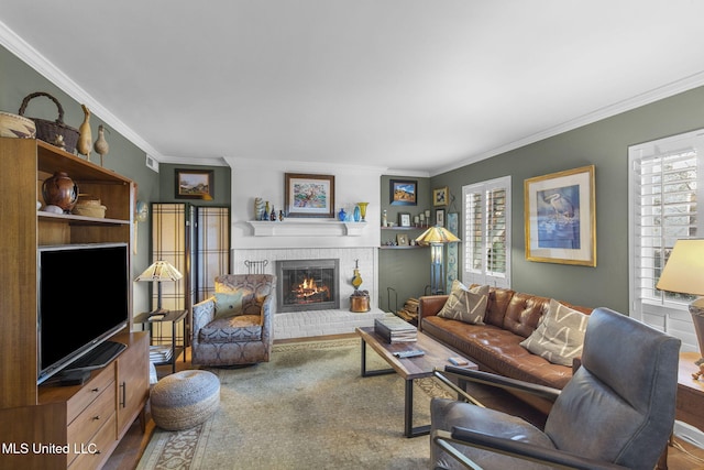 living room featuring crown molding and a brick fireplace