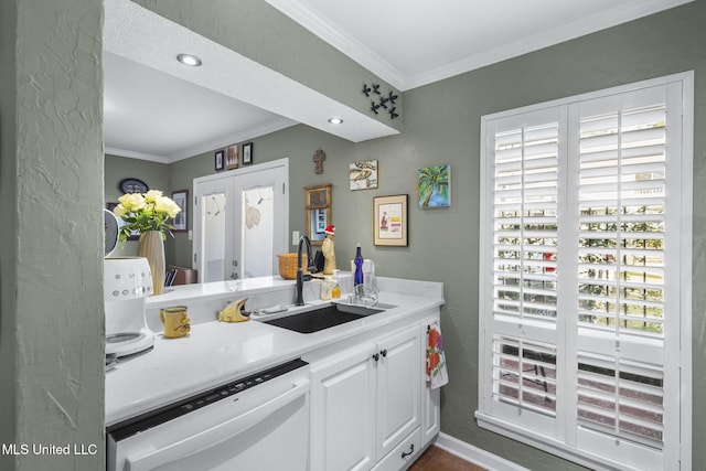 kitchen featuring white cabinets, sink, white dishwasher, and plenty of natural light