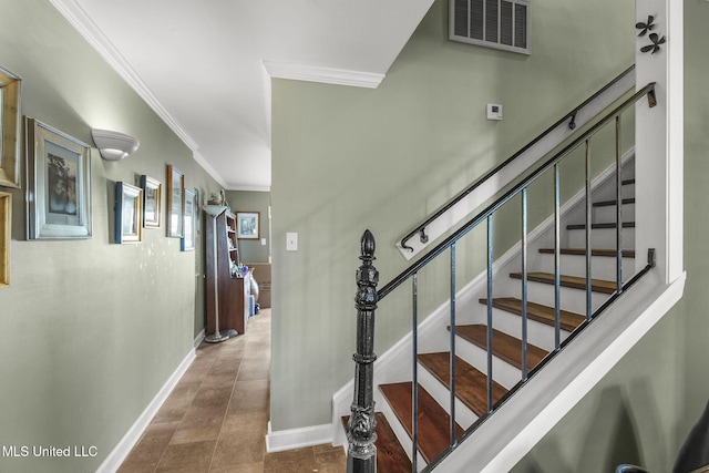 staircase featuring tile patterned flooring and ornamental molding