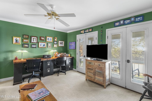 carpeted home office with ceiling fan, a healthy amount of sunlight, crown molding, and french doors