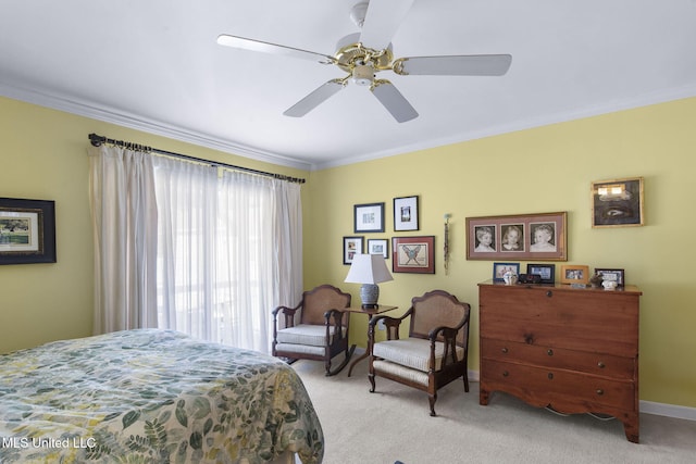 carpeted bedroom featuring ceiling fan and crown molding