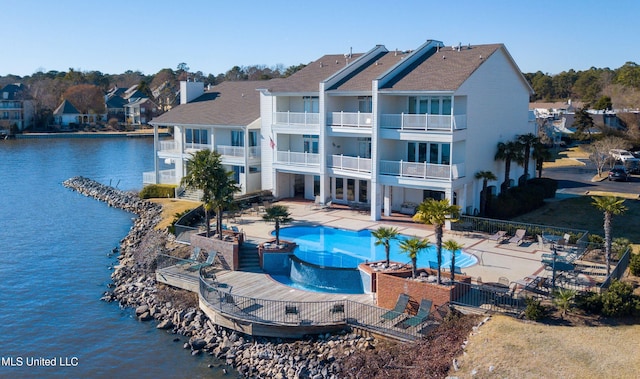 view of pool featuring a patio area and a water view