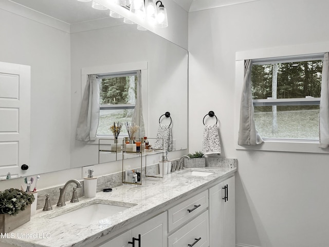 bathroom with vanity and crown molding