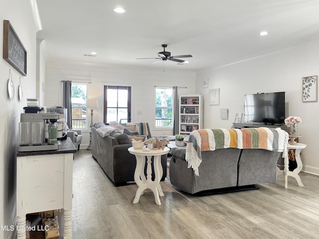 living room with ceiling fan and light wood-type flooring