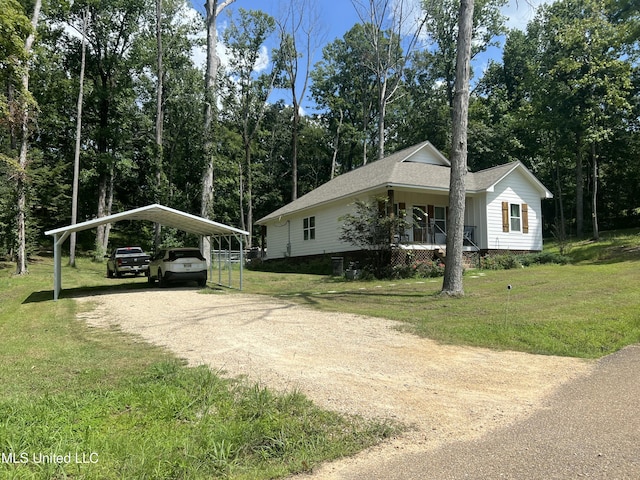 view of side of property with a carport, a porch, and a yard