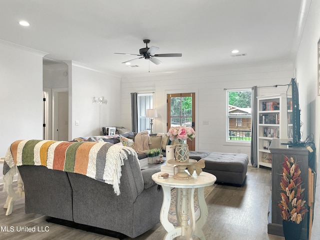 living room with ceiling fan, ornamental molding, and dark hardwood / wood-style flooring