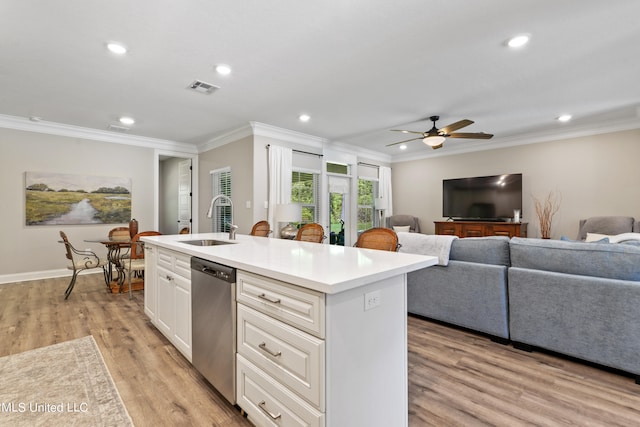 kitchen with dishwasher, a center island with sink, sink, light wood-type flooring, and ceiling fan