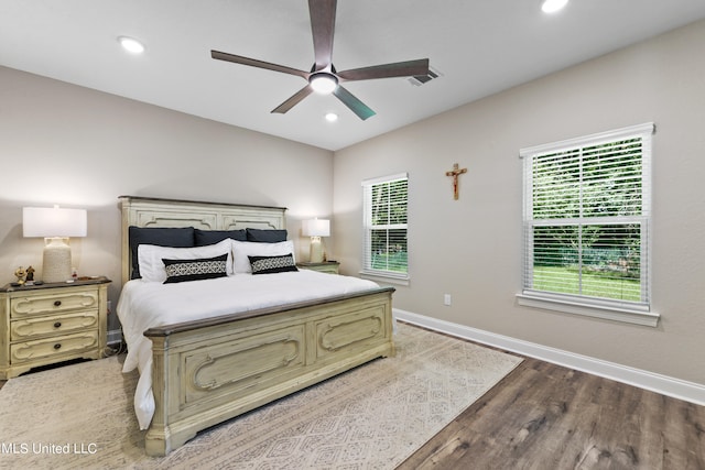 bedroom with ceiling fan and hardwood / wood-style flooring