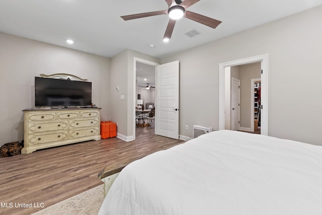 bedroom with wood-type flooring and ceiling fan