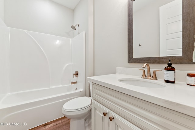 full bathroom featuring toilet, vanity, wood-type flooring, and washtub / shower combination