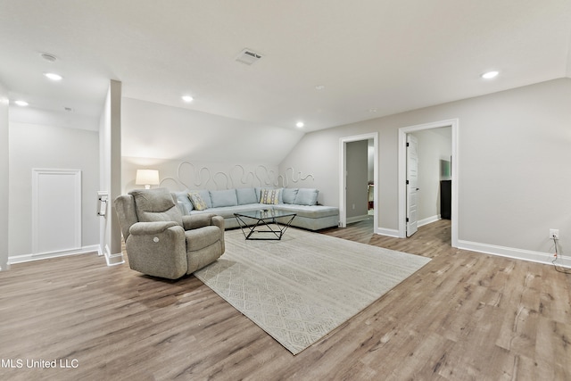 living room featuring light hardwood / wood-style floors and lofted ceiling