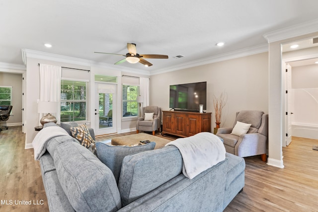 living room with light hardwood / wood-style flooring, crown molding, and ceiling fan