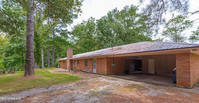 back of house featuring a carport