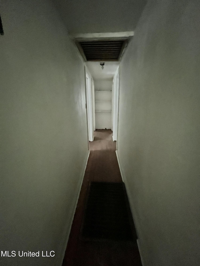 hall featuring baseboards