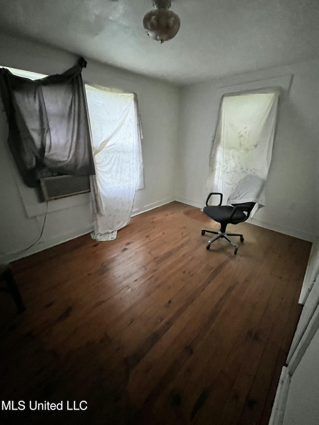 unfurnished bedroom with wood finished floors and baseboards