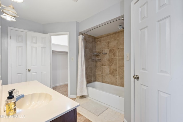 bathroom featuring tile patterned floors, vanity, and shower / bath combo with shower curtain