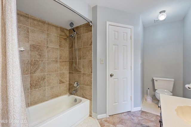 full bathroom featuring tile patterned flooring, vanity, toilet, and tiled shower / bath