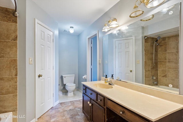 full bathroom with vanity, tiled shower / bath combo, and toilet