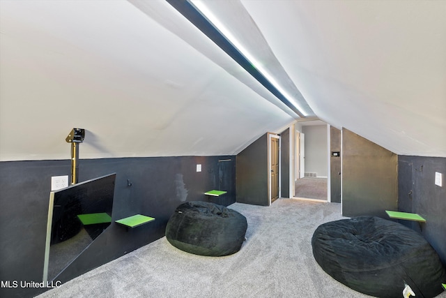 additional living space featuring carpet and lofted ceiling